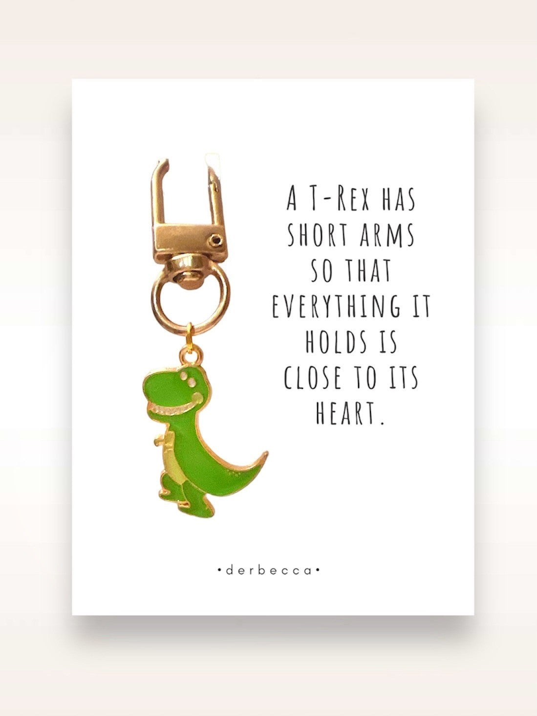 T-Rex Dinosaur Mini Keychain Charm Pendant, Bag Charm, Zipper Pull Accessory in green & yellow gold with a saying/verse card that reads: A T-Rex has short arms so that everything it holds is close to its heart.