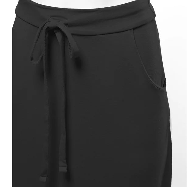 close up zoomed in front angled view product photo of a solid black maxi skirt with pockets and an adjustable drawstring waist tie