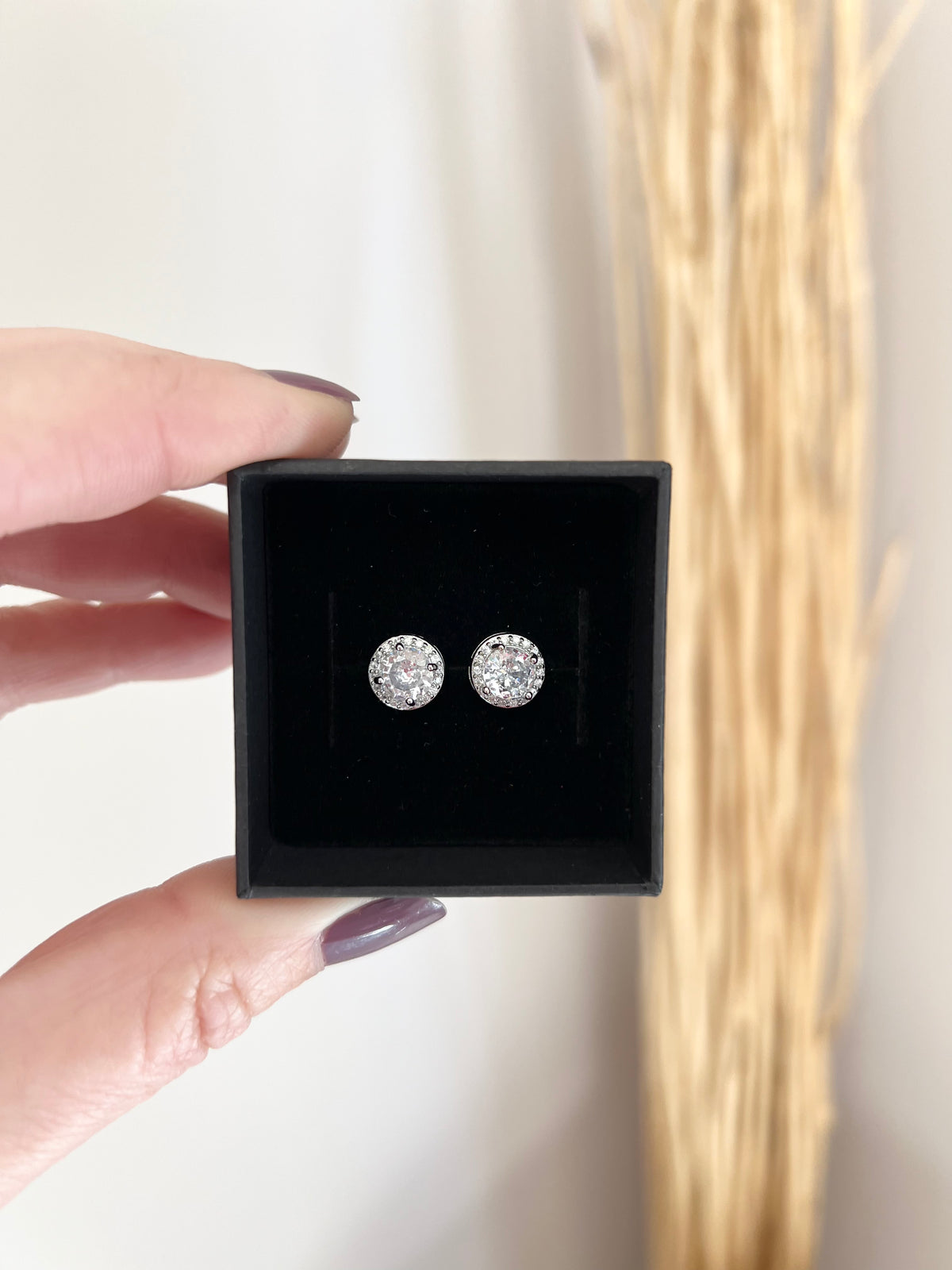 Moissanite Stud Earrings | Round or Square Cushion Halo Setting | Material: 925 sterling silver rhodium-plated | Length: 1.25" | Solitaire: 2 carat (1 carat per earring) | Weight: 0.2 oz (6 g) for set