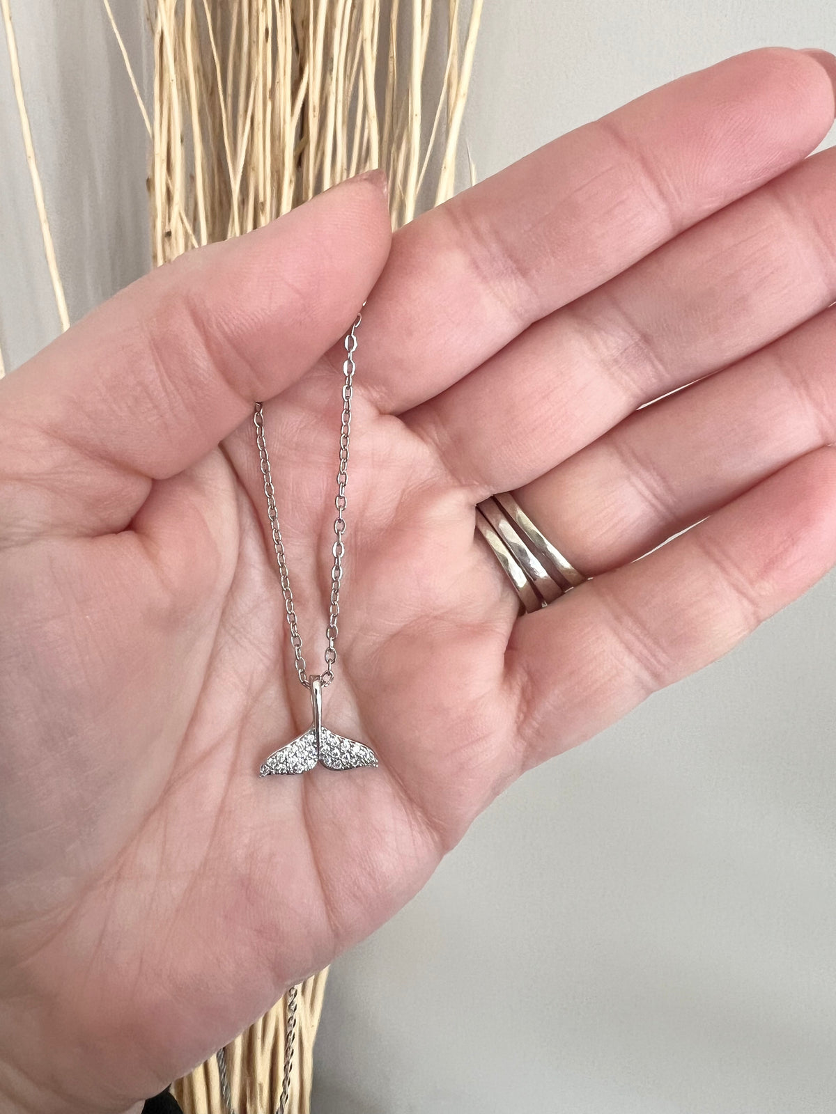 Silver Necklace | Dolphin Tail | Whale Tail | Mermaid Tail | The Tail the Truth Pendant Necklace features a majestic tail crafted with exquisite detail. Only the discerning will know...is it a dolphin, whale, or mermaid tail? Wearing one of these pendants is believed to be a symbol of well-being and protection. Let this pendant be a reminder that you are strong, protected, and loved.