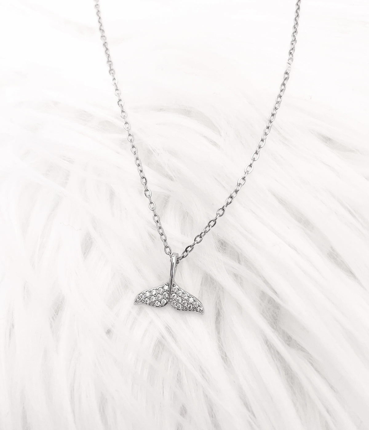 Silver Necklace | Dolphin Tail | Whale Tail | Mermaid Tail | The Tail the Truth Pendant Necklace features a majestic tail crafted with exquisite detail. Only the discerning will know...is it a dolphin, whale, or mermaid tail? Wearing one of these pendants is believed to be a symbol of well-being and protection. Let this pendant be a reminder that you are strong, protected, and loved.