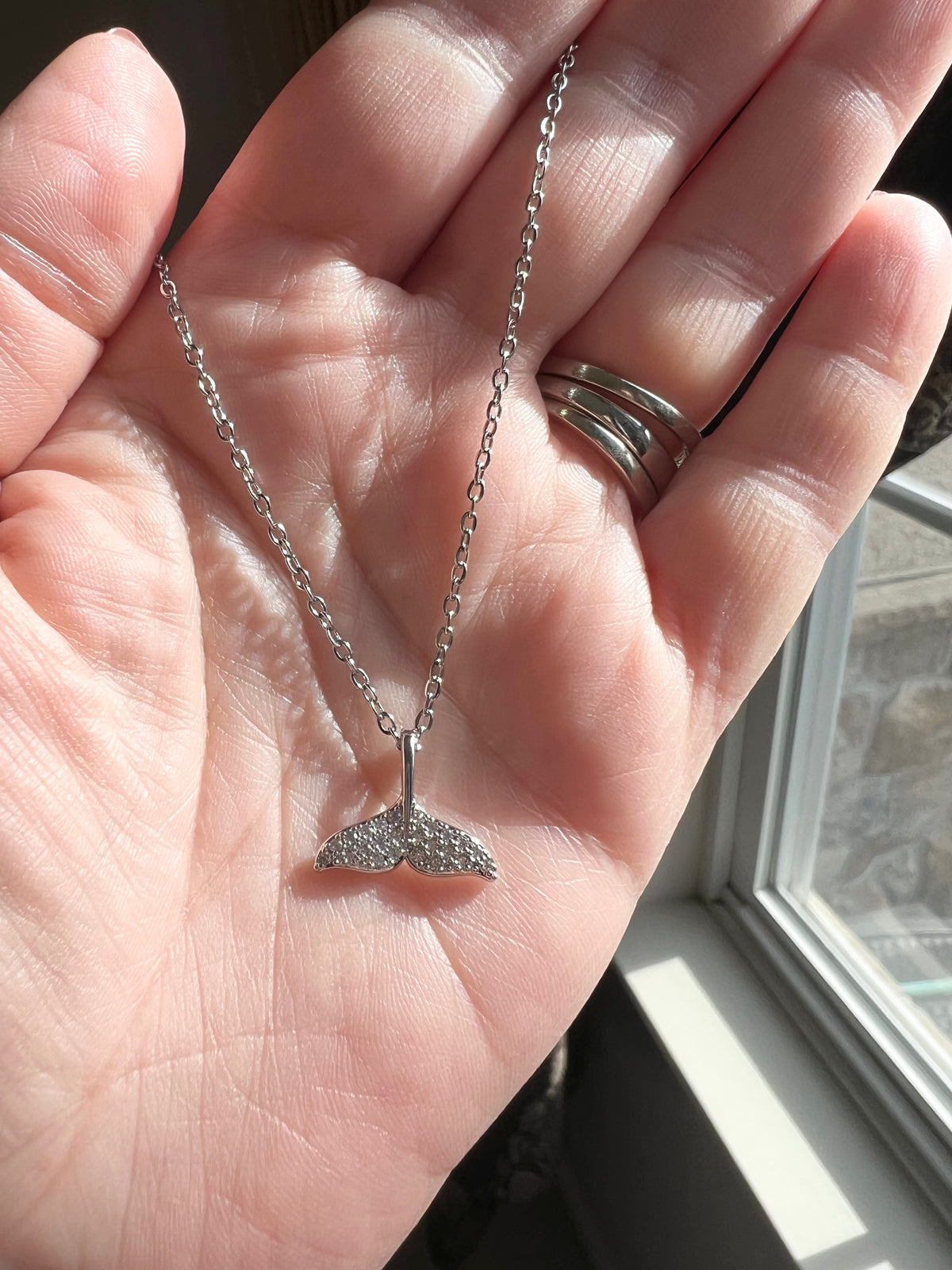 Silver Necklace | Dolphin Tail | Whale Tail | Mermaid Tail | The Tail the Truth Pendant Necklace features a majestic tail crafted with exquisite detail. Only the discerning will know...is it a dolphin, whale, or mermaid tail? Wearing one of these pendants is believed to be a symbol of well-being and protection. Let this pendant be a reminder that you are strong, protected, and loved.