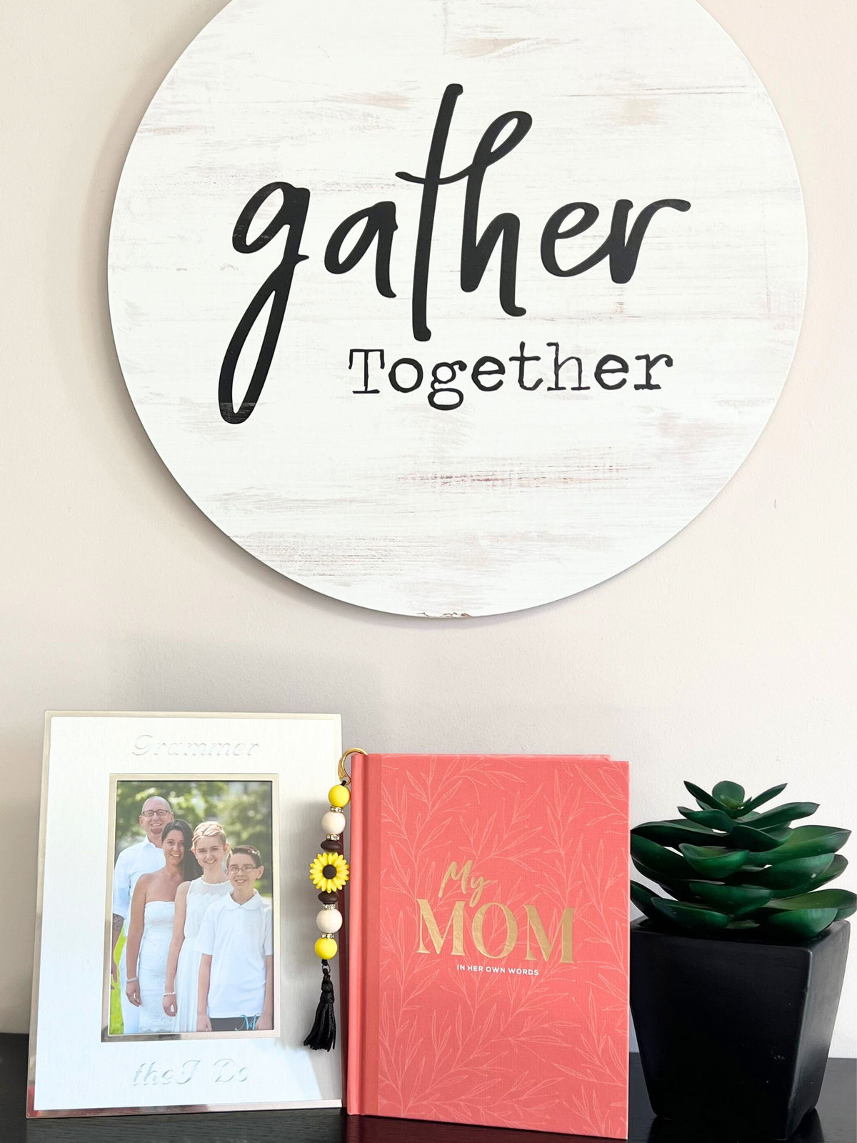 Family photo on a shelf with a Mom journal book and silicone beaded bookmark and a small faux plant