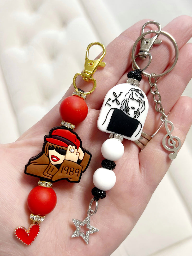 Swiftie Taylor Swift Silicone Keychain Black & White or 1989 Brown & Red with Hat Option. Includes Silicone Focal Bead, Silicone Accent Beads, Bead Spacers and Optional Keyring Split Ring Charms & Tassels.