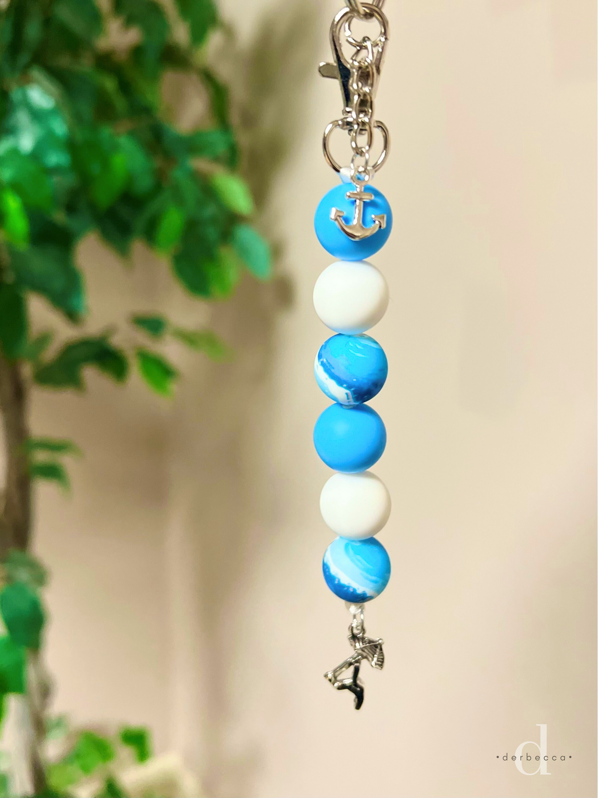 Blue, White, and Ocean Print Silicone Bead Keychain with 6 beads and a swivel Lobster Clasp and Split Keyring with Chain and Anchor Charm finished with a charm with a beach umbrella and beach chair