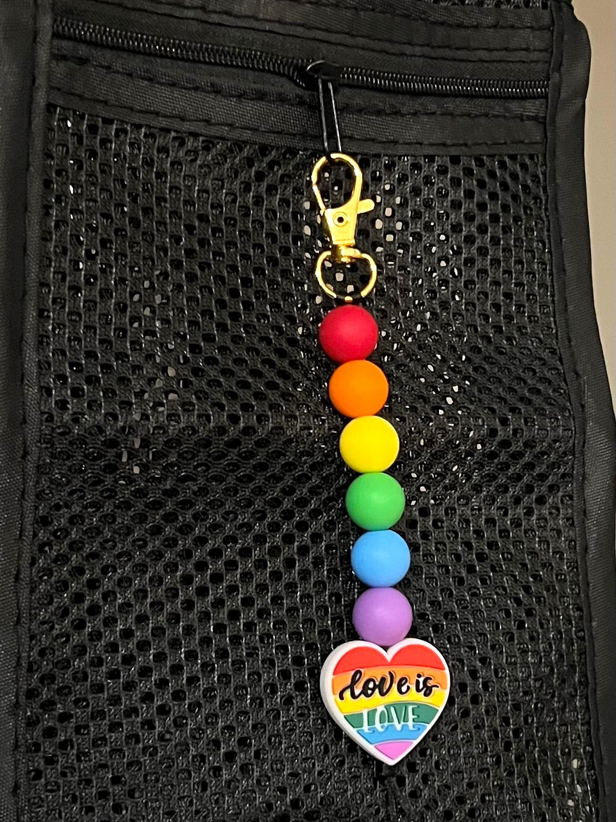 Fishnet Bag with a Love is Love Rainbow Heart Silicone Bead Charm Dangle clipped to the zipper
