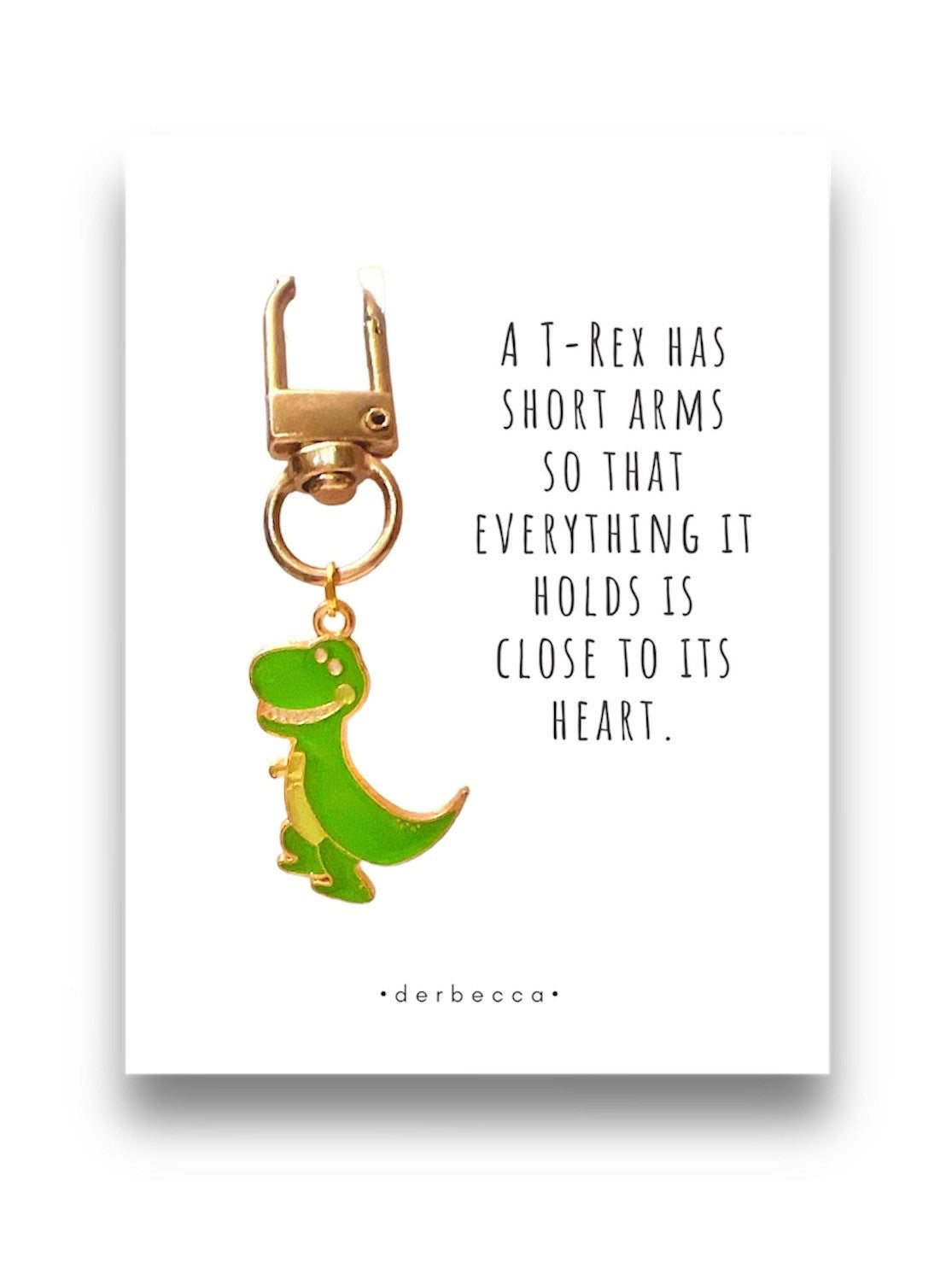 T-Rex Dinosaur Mini Keychain Charm Pendant, Bag Charm, Zipper Pull Accessory in green & yellow gold with a saying/verse card that reads: A T-Rex has short arms so that everything it holds is close to its heart.