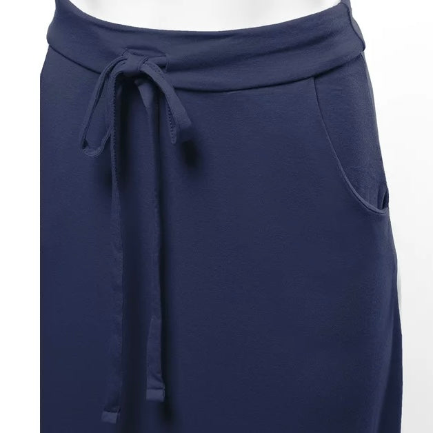 close up zoomed in front angled view product photo of a solid navy blue maxi skirt with pockets and an adjustable drawstring waist tie