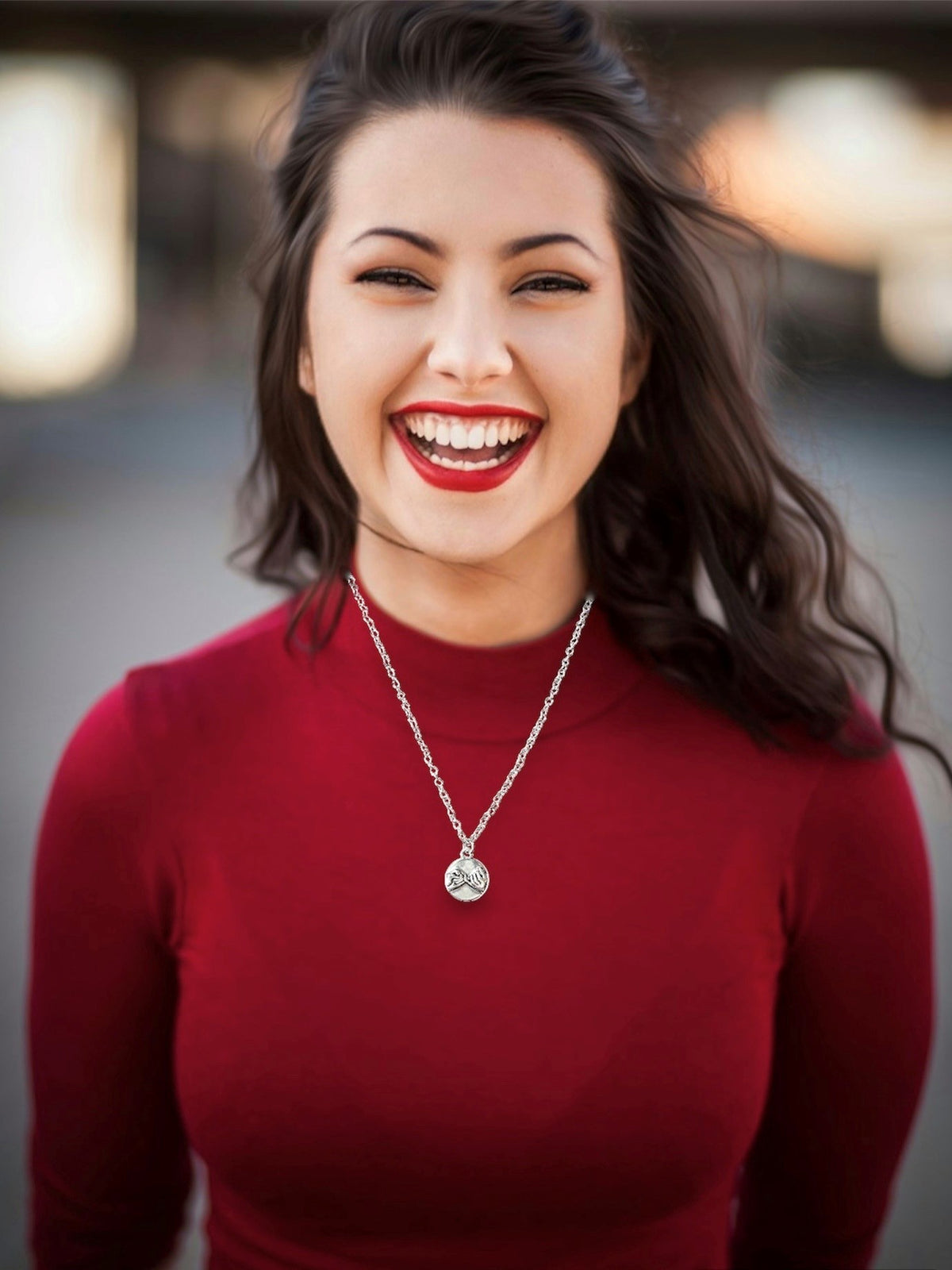 Dark haired smiling woman with red lipstick wearing a Pink Promise Silver Pendant Charm Necklace with 2 hands locking pinky fingers