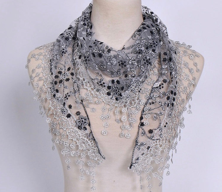 Black and Greyish Silver embroidered shawl shoulder drape triangle scarf with tassels on a plain background