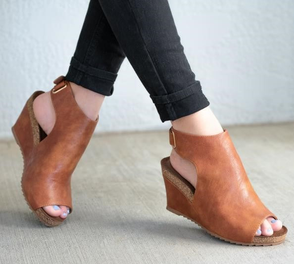 Need comfortable stylish wedges with easy on-off feature? Our High Vamp Open Heeled Calypso Wedge heel Sandal is for you! Featuring: Adjustable Velcro Back Ankle Strap, Upper PU, 3" Heel Height, 3/4" Platform Height, 2 Piece Cork and Wrapped Midsole, and Padded Insole. Brown Cognac Wedge  Heel.