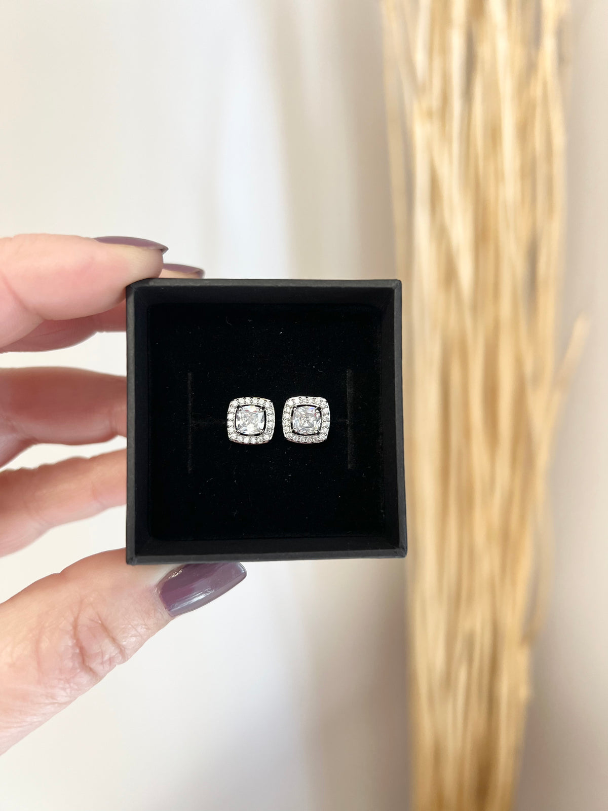 Moissanite Stud Earrings | Round or Square Cushion Halo Setting | Material: 925 sterling silver rhodium-plated | Length: 1.25" | Solitaire: 2 carat (1 carat per earring) | Weight: 0.2 oz (6 g) for set